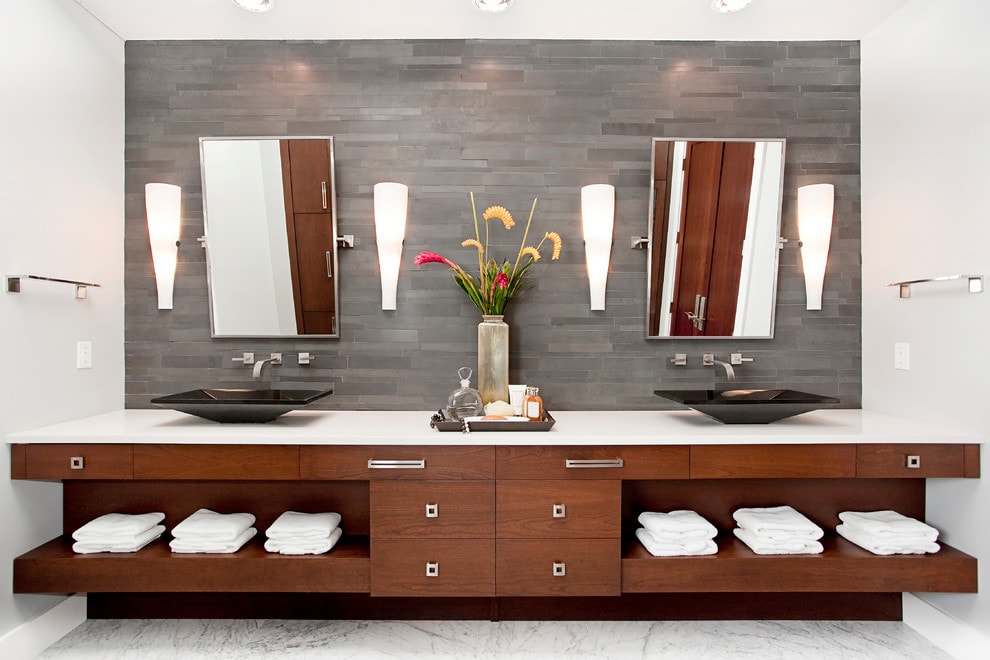 Norstone Grey Basalt Lynia Interlocking Tiles on wall behind double vanity with vessal sinks and floating mirrors